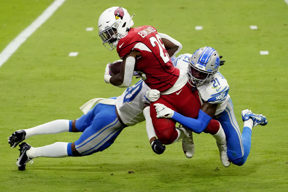 Arizona Cardinals running back Chase Edmonds (29) is hit by Detroit Lions defensive back Tracy Walker (21) andcornerback Jeff Okudah during the first half of an NFL football game, Sunday, Sept. 27, 2020, in Glendale, Ariz. (AP Photo/Rick Scuteri)