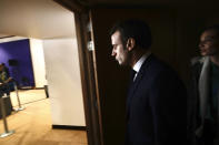 French President Emmanuel Macron prepares to address a media conference at the conclusion of an EU summit in Brussels, Friday, Dec. 13, 2019. European Union leaders are gathered Friday to discuss Britain's departure from the bloc amid some relief that Prime Minister Boris Johnson has secured an election majority that should allow him to push the Brexit deal through parliament. (AP Photo/Olivier Matthys)