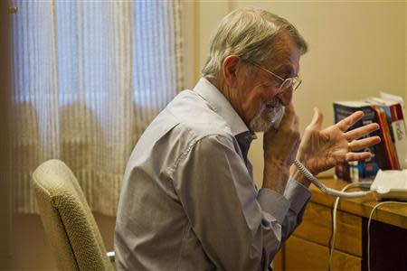 Martin Karplus speaks on the phone after winning the 2013 Nobel Prize for chemistry, at his home in Cambridge, Massachusetts October 9, 2013. REUTERS/Dominick Reuter