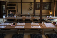 A tourist eat her lunch in a restaurant in Nara, Japan, March 19, 2020. Nara was among the first Japanese town hit by the COVID-19 in late January, when a tour bus driver in town tested positive for the virus, becoming the first Japanese patient after carrying tourists from Wuhan, the epicenter of the pandemic. (AP Photo/Jae C. Hong)