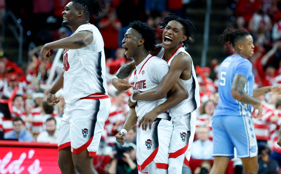 N.C. State’s Terquavion Smith (0) celebrates with Jarkel Joiner (1) after Joiner hit a three-pointer to put the Wolfpack up 67-60 during the second half of N.C. State’s 77-69 victory over UNC at PNC Arena in Raleigh, N.C., Sunday, Feb. 19, 2023.