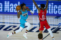 Memphis Grizzlies' Ja Morant (12) misses a shot at the buzzer over New Orleans Pelicans' Nickeil Alexander-Walker (0) during the first half of an NBA basketball game Monday, Aug. 3, 2020 in Lake Buena Vista, Fla. (AP Photo/Ashley Landis, Pool)