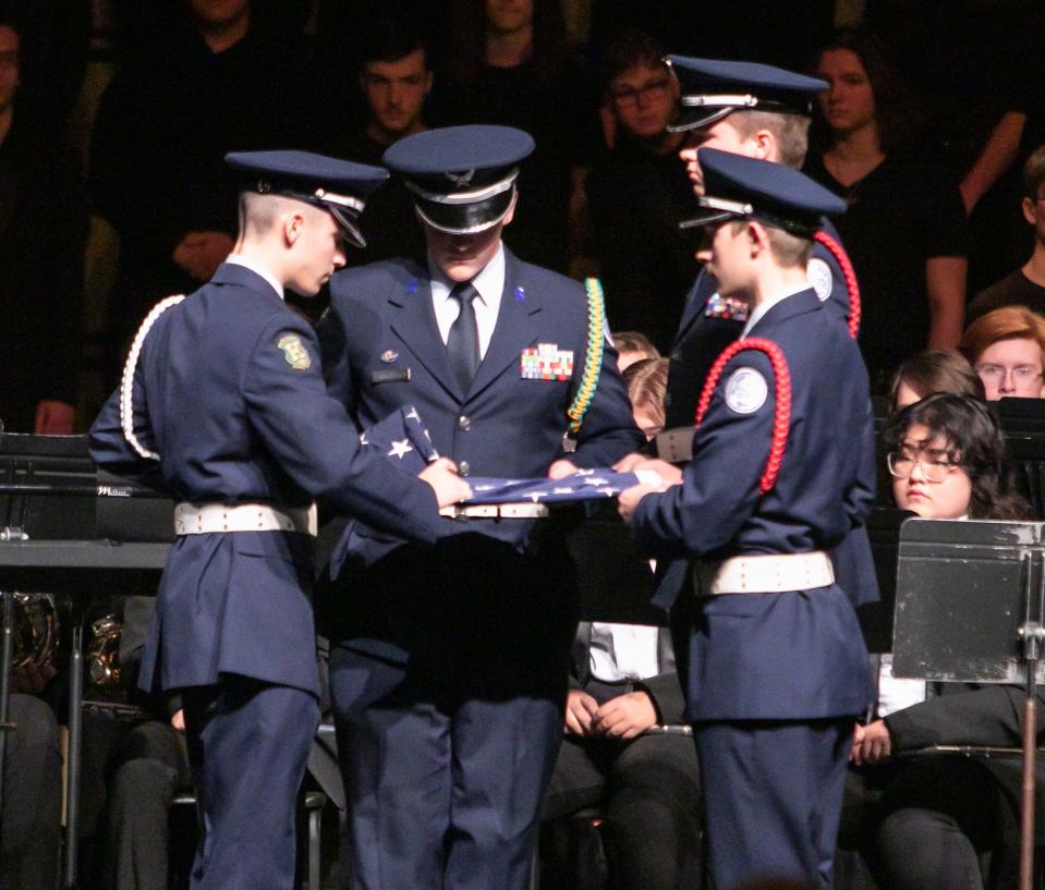 Members of Howell High School's Junior ROTC fold the American flag near the end of the school's annual Veterans Day assembly Friday, Nov. 11, 2022.