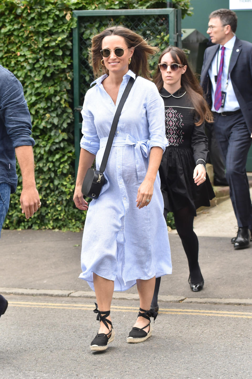 <p>For day nine of Wimbledon 2018, Pippa Middleton made a surprise appearance alongside her mother, Carole. The Duchess of Cambridge’s sister dressed her bump in a £117.67 Ralph Lauren shirt <a rel="nofollow noopener" href="https://www.saksfifthavenue.com/polo-ralph-lauren-striped-shirt-dress/product/0400097692208?LScreativeid=1&siteID=k.8oqcSrcmY-6XOwwjAJ4MOADqEhqVEmNg&site_refer=AFF001&ranSiteID=k.8oqcSrcmY-6XOwwjAJ4MOADqEhqVEmNg&mid=13816&ranMID=13816&ranEAID=k*8oqcSrcmY&LSoid=365991&LSlinkid=10" target="_blank" data-ylk="slk:dress" class="link ">dress</a> and in a surpising fashion move, finished the look with a Pop and Suki cross-body bag. <em>[Photo: Getty]</em> </p>