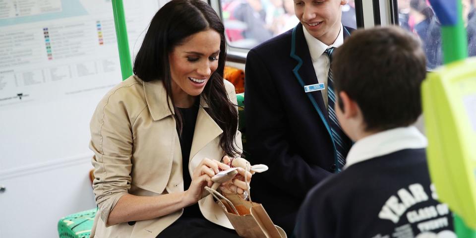 <p>Meghan meets schoolchildren on a bus.</p>