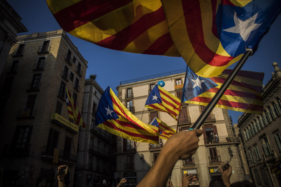 <p>People wave independence flags just after the speech of Catalan regional president Carles Puigdemont in Barcelona, Spain, Thursday, Oct. 26, 2017. Puigdemont said Thursday he considered calling a snap election, but was choosing not to because he didn’t receive enough guarantees that the government’s “abusive” moves to take control of Catalonia would be suspended. (AP Photo/Santi Palacios) </p>