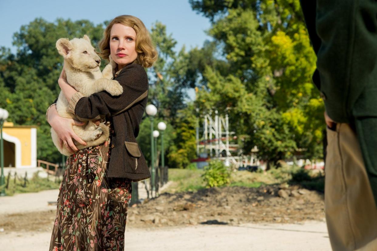 a woman holds a lion cub in a scene from the zookeeper's wife, a good housekeeping pick for best sad movies on netflix