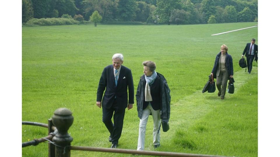 Princess Anne walking in a field in white jeans