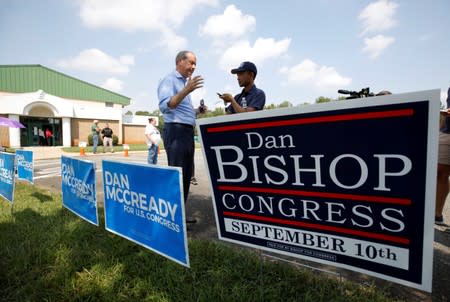 Dan Bishop, Republican candidate in the special election for North Carolina's 9th Congressional District, speaks to the media near campaign signs for him and for his Democratic opponent Dan McCready, outside a polling station in Indian Trail, North Carolin