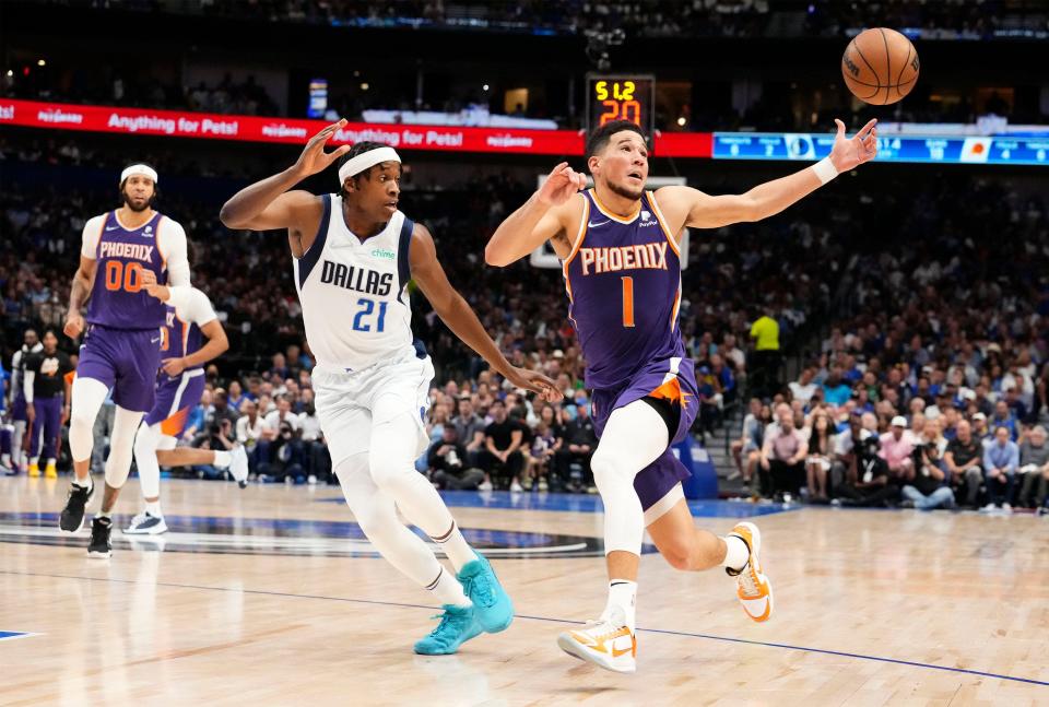 Phoenix Suns guard Devin Booker (1) is pressured by Dallas Mavericks guard Frank Ntilikina (21) during Game 3.