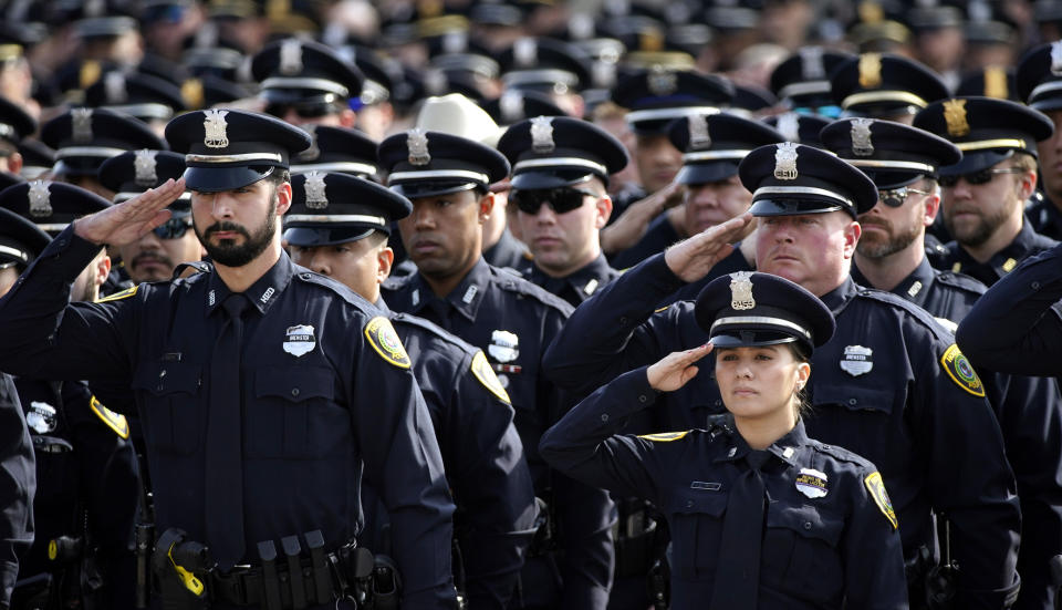 Houston Police Officers salute during a funeral service for Houston police Sgt. Christopher Brewster, Thursday, Dec. 12, 2019, at Grace Church Houston in Houston. Brewster, 32, was gunned down Saturday evening, Dec. 7, while responding to a domestic violence call in Magnolia Park. Police arrested 25-year-old Arturo Solis that night in the shooting death. Solis faces capital murder charges. (AP Photo/David J. Phillip)