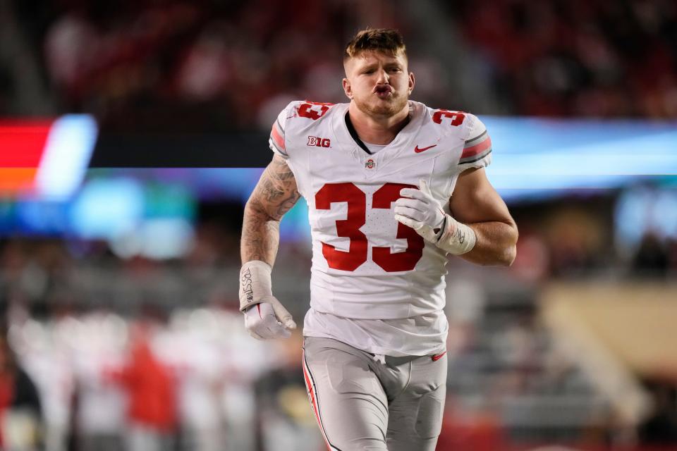 Oct 28, 2023; Madison, Wisconsin, USA; Ohio State Buckeyes defensive end Jack Sawyer (33) warms up on the sideline during the second half of the NCAA football game against the Wisconsin Badgers at Camp Randall Stadium. Ohio State won 24-10.