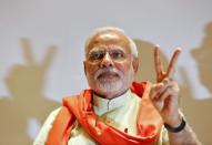 Hindu nationalist Narendra Modi, the prime ministerial candidate for Bharatiya Janata Party (BJP), gestures upon his arrival to meet his party leaders and workers at Gandhinagar in Gujarat May 13, 2014. REUTERS/Amit Dave