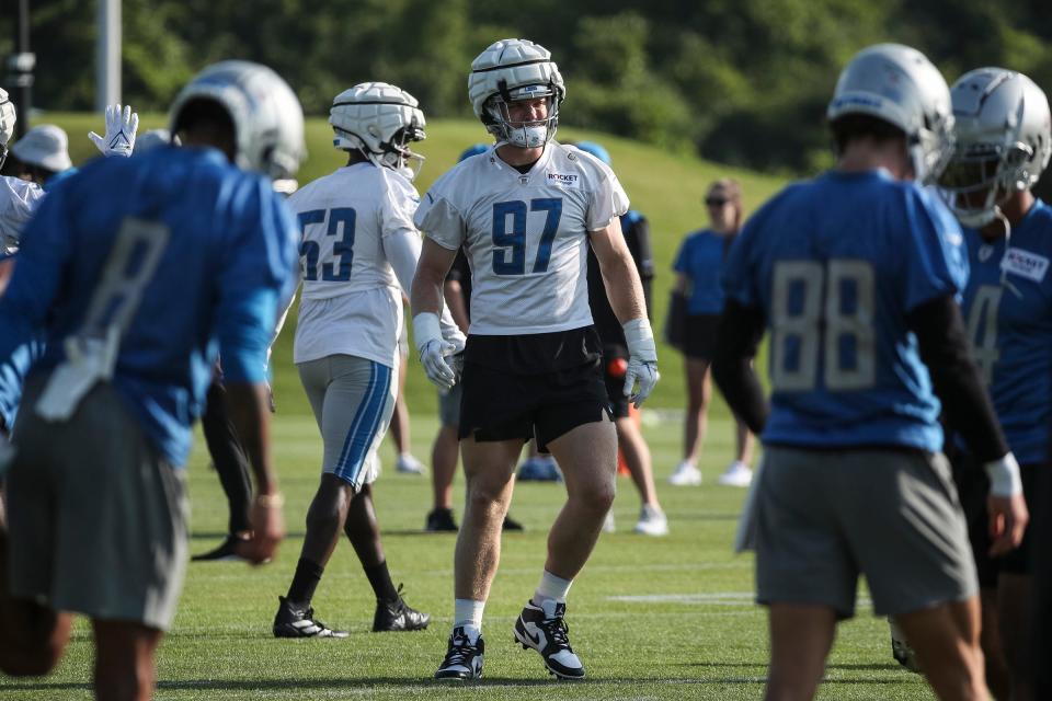Detroit Lions defensive end Aidan Hutchinson warms up during training camp at Detroit Lions Headquarters and Training Facility in Allen Park on Monday, July 24, 2023.