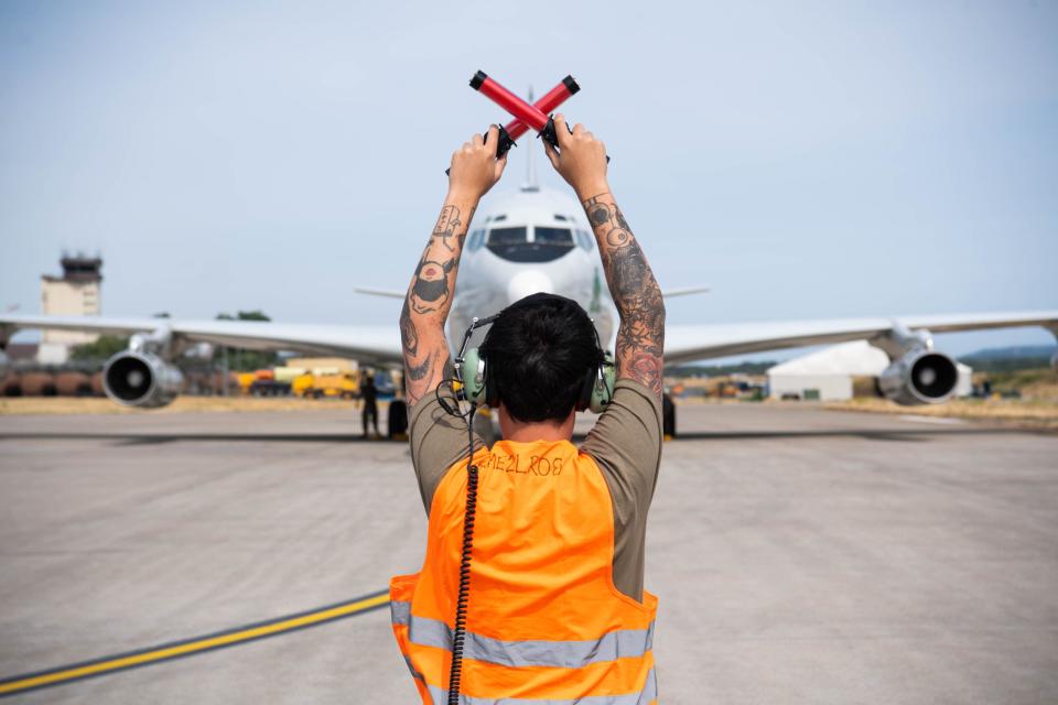 A crew chief marshals an E-8C JSTARS prior to the type’s retirement. <em>U.S. Air Force/Airman 1st Class Jared Lovett</em>