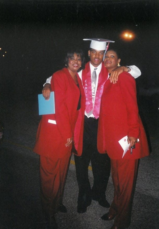 From left to right: Regina Oliver, Andre Emmett and Karen Oliver-Thomas attend Emmett's graduation May 2000 at Carter High School in Dallas.