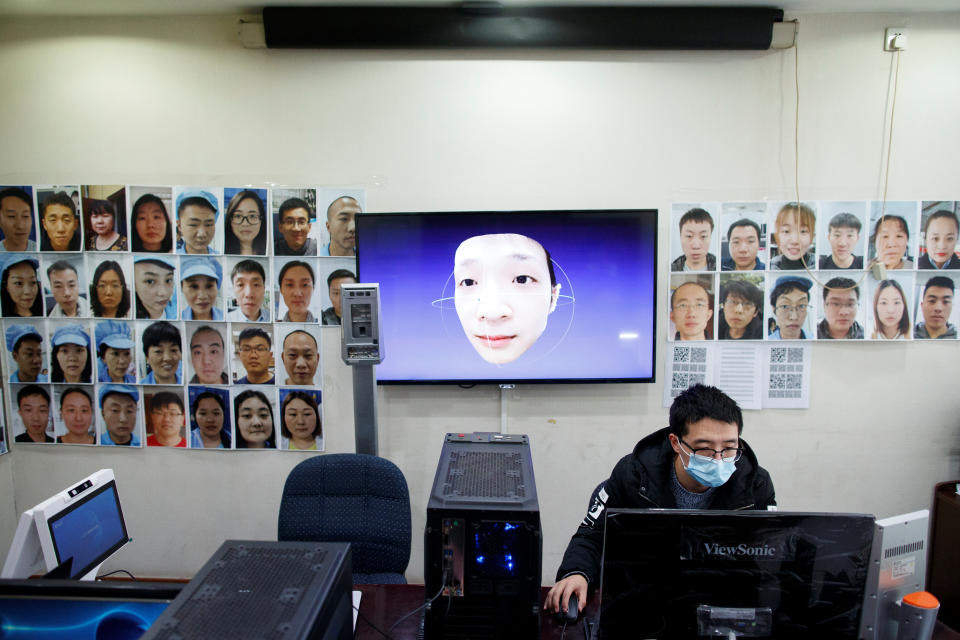 A software engineer works on a facial recognition program that identifies people when they wear a face mask at the development lab of the Chinese electronics manufacturer Hanwang (Hanvon) Technology in Beijing as the country is hit by an outbreak of the novel coronavirus (COVID-19), China, March 6, 2020. Picture taken March 6, 2020.  REUTERS/Thomas Peter