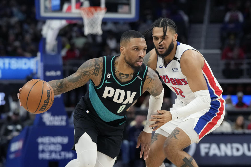 Portland Trail Blazers guard Damian Lillard (0) drives as Detroit Pistons forward Isaiah Livers (12) defends during the first half of an NBA basketball game, Monday, March 6, 2023, in Detroit. (AP Photo/Carlos Osorio)