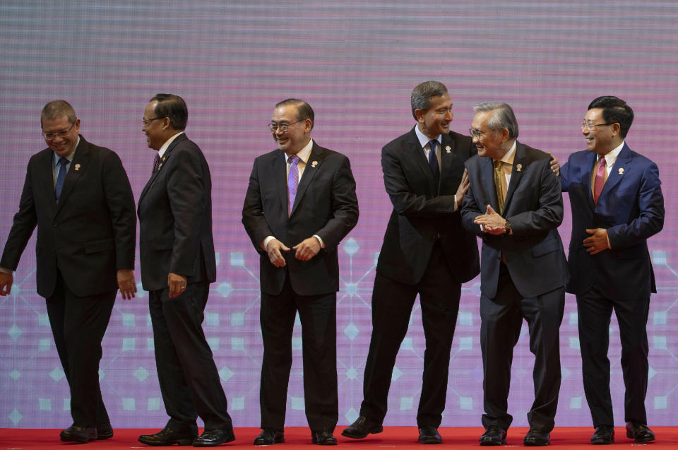 From left, Malaysia Foreign Minister Saifuddin Abdullah, Myanmar Minister of State for Foreign Affaires Kyaw Tin, Philippines Foreign Affaires Secretary Teodoro Locsin Jr., Singapore Foreign Minister Vivian Balakrishnan, Thailand Foreign Minister Don Pramudwinai and Vietnam Foreign Minister Pham Binh Minh, prepare to walk back to their seats after posing for a group photo during the Association of Southeast Asian Nations (ASEAN) Foreign Ministers' meeting in Bangkok, Thailand, Saturday, June 22, 2019. (AP Photo/Gemunu Amarasinghe)