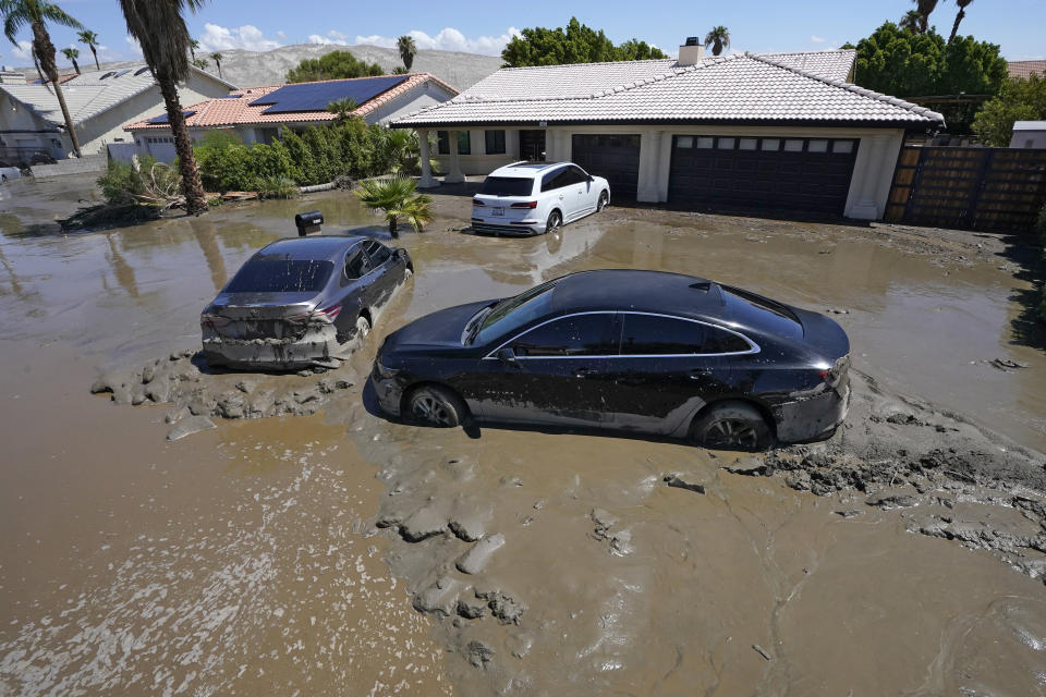 Cars are seen stuck in the mud after the street was flooded Monday, Aug. 21, 2023, in Cathedral City, Calif. Forecasters said Tropical Storm Hilary was the first tropical storm to hit Southern California in 84 years, bringing the potential for flash floods, mudslides, isolated tornadoes, high winds and power outages. (AP Photo/Mark J. Terrill)