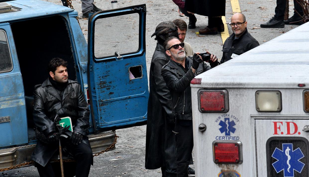 Jeffrey Dean Morgan takes photos as he waits on set while filming for "The Walking Dead: Dead City" on Norwich Street Monday.