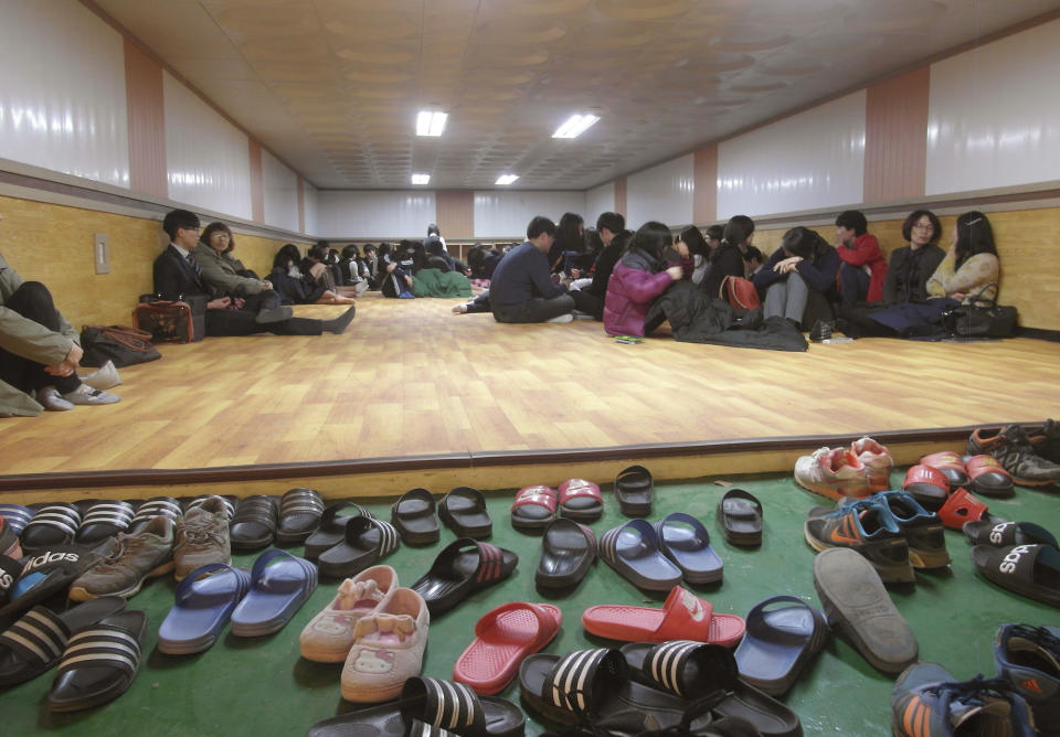 Residents and students of Yeonpyeong Island evacuate to a shelter on the island, South Korea, near the West Sea border with North Korea, Monday, March 31, 2014. North and South Korea fired artillery shells into each other's waters Monday, a flare-up of animosity between the rivals that forced residents of five front-line South Korean islands to evacuate to shelters, South Korean officials said. (AP Photo) KOREA OUT