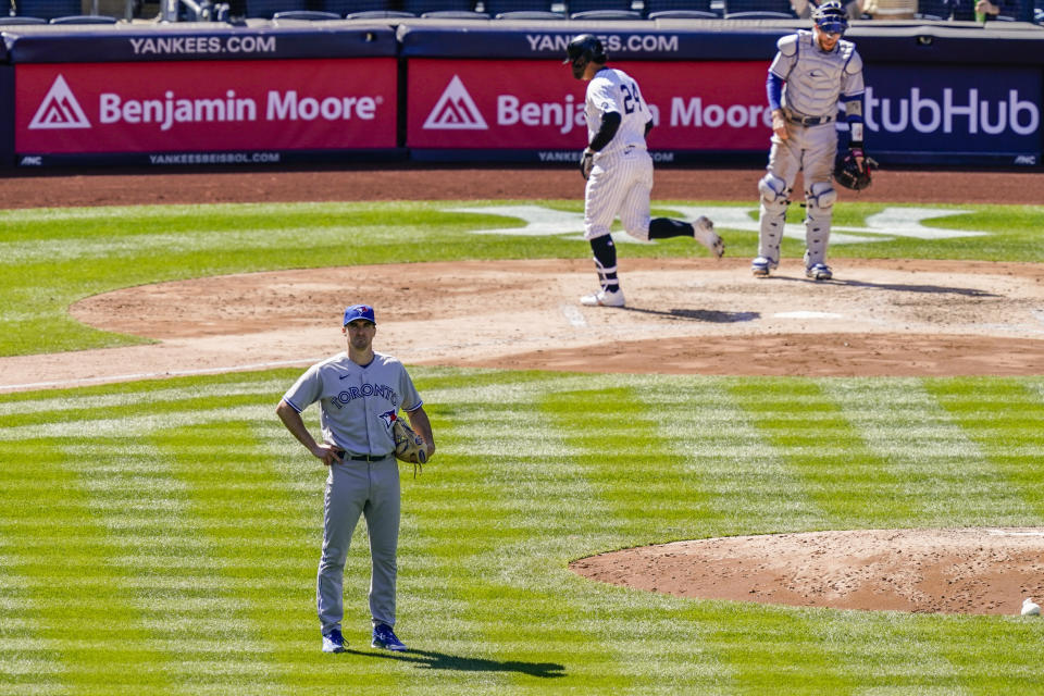 Toronto Blue Jays starting pitcher Ross Stripling, left, reacts after giving up a home run to New York Yankees' Gary Sanchez during the fourth inning of a baseball game, Saturday, April 3, 2021, in New York. (AP Photo/John Minchillo)