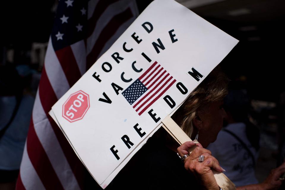 Anti-vaccine rally protesters hold signs outside of Houston Methodist Hospital in Houston, Texas, on June 26, 2021. - A spokesperson for Houston Methodist Hospital said on June 23, 153 employees either resign or were fired for refusing to be vaccinated.
