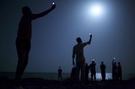 John Stanmeyer, a U.S. photographer working for VII agency on assignment for National Geographic, won the World Press Photo of the Year 2013 contest with this picture of African migrants on the shore of Djibouti city at night taken February 26, 2013. The prize-winning entries of the World Press Photo Contest 2014, the world's largest annual press photography contest, were announced February 14, 2014. Jury member Jillian Edelstein said about the winning image: "It's a photo that is connected to so many other stories-it opens up discussions about technology, globalization, migration, poverty, desperation, alienation, humanity. It's a very sophisticated, powerfully nuanced image. It is so subtly done, so poetic, yet instilled with meaning, conveying issues of great gravity and concern in the world today." REUTERS/John Stanmeyer/World Press Photo Handout via Reuters