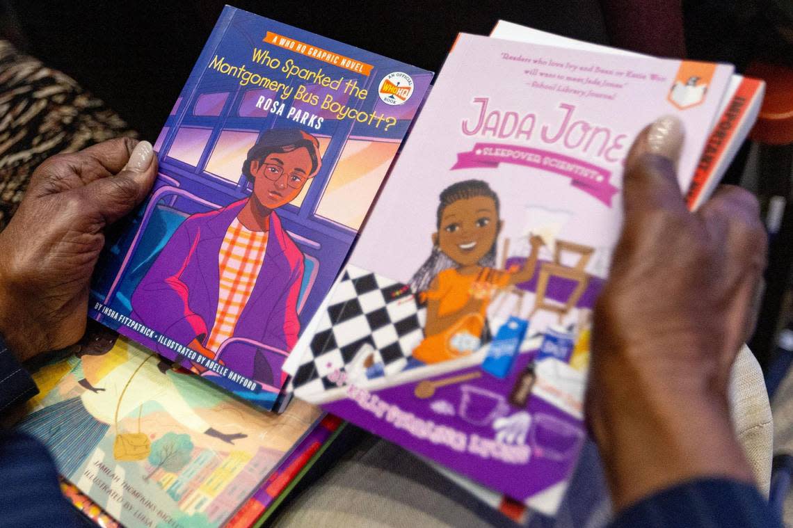 An attendee holds Black history books during an education town hall at Antioch Missionary Baptist Church in Miami Gardens, Florida, on Thursday, Aug. 10, 2023. The town hall was convened after the Florida Board of Education adopted new standards for teaching Black history that many have criticized.