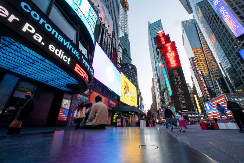 News related to coronavirus disease (COVID-19) are seen on a display at Times Square in New York City, New York