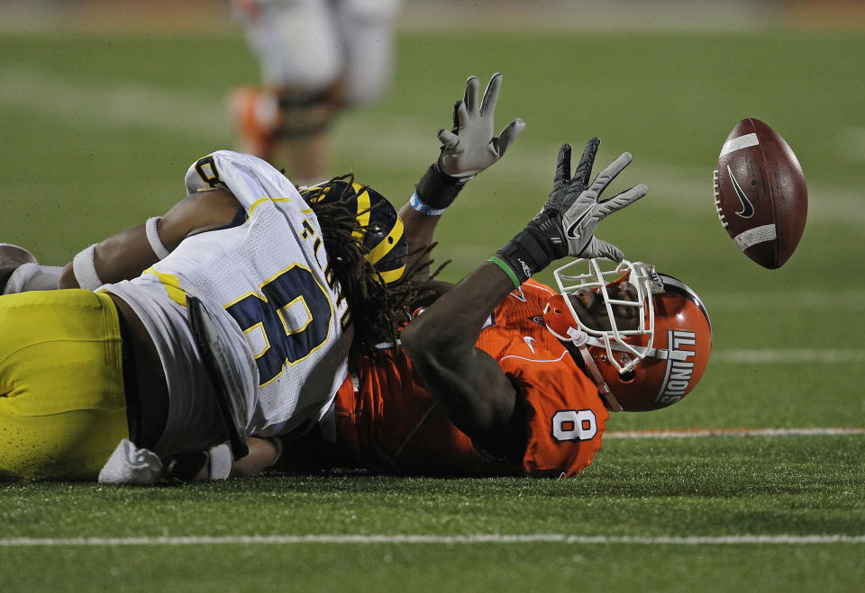 CHAMPAIGN, IL - NOVEMBER 12: A.J. Jenkins #8 of the Illinois Fighting Illini can't hold on to the ball after being hit by J.T. Floyd #8 of the Michigan Wolverines at Memorial Stadium on November 12, 2011 in Champaign, Illinois. Michigan defeated Illinois 31-14. (Photo by Jonathan Daniel/Getty Images)