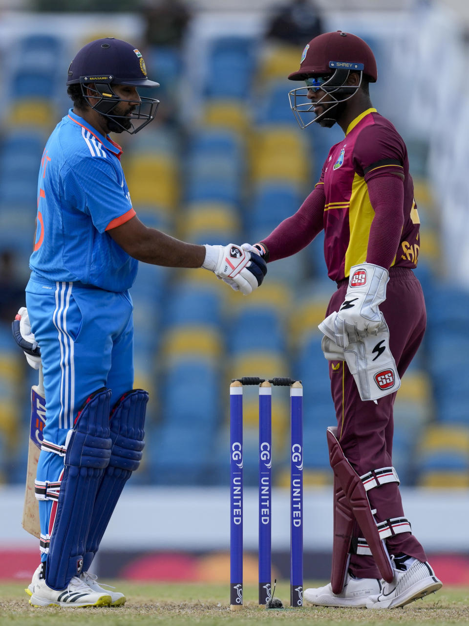 India's captain Rohit Sharma, left, and West Indies' captain Shai Hope shake hands at the end of their first ODI cricket match at Kensington Oval in Bridgetown, Barbados, Thursday, July 27, 2023. India won by five wickets. (AP Photo/Ricardo Mazalan)