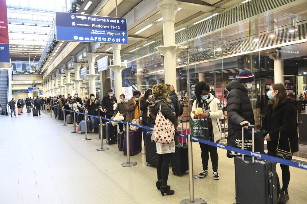 People at St Pancras station in London, wait to board the last train to Paris today, Sunday Dec. 20, 2020. (Stefan Rousseau/PA via AP)