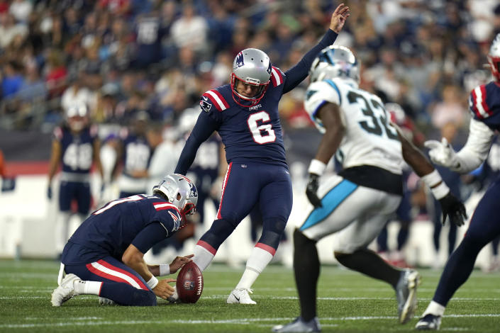 New England Patriots place-kicker Nick Folk (6) hits an extra point from the hold of Jake Bailey (7), while Carolina Panthers cornerback Tae Hayes (32) defends during the first half of a preseason NFL football game Friday, Aug. 19, 2022, in Foxborough, Mass. (AP Photo/Charles Krupa)