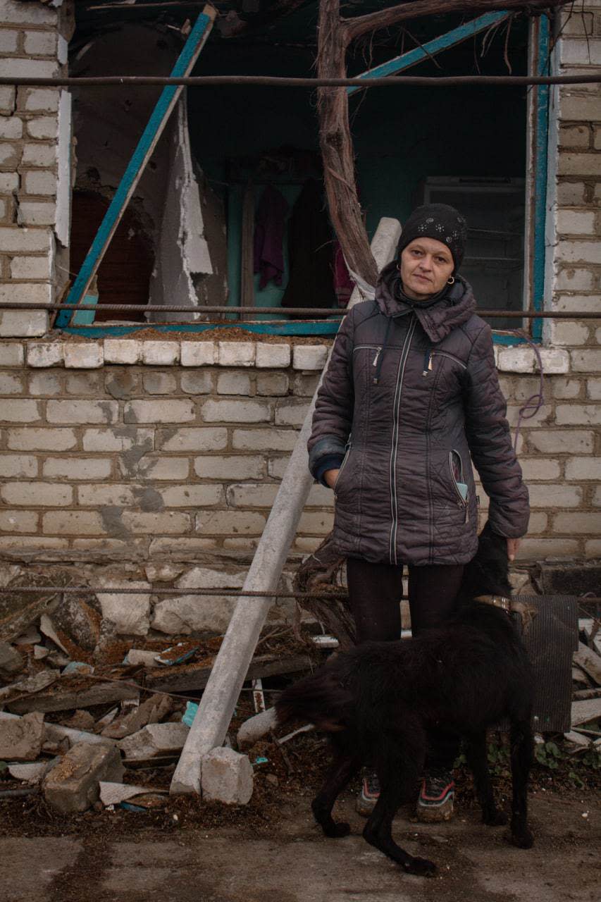 <div class="inline-image__caption"><p>Tatiana and her dog outside her damaged house.</p></div> <div class="inline-image__credit">Courtesy of Tom Mutch </div>