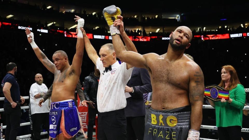 Referee Steve Gray raises the arms of both Fabio Wardley and Frazer Clarke after announcing the contest a draw