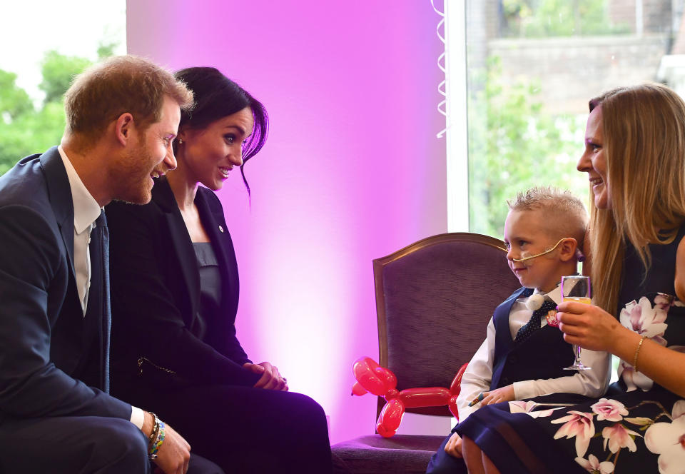 Duke and Duchess of Sussex meet four-year-old McKenzie Brackley ahead of the WellChild Awards [Photo: PA]