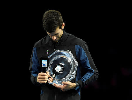 Tennis - ATP Finals - The O2, London, Britain - November 18, 2018 Second placed Serbia's Novak Djokovic celebrates with a trophy after losing the final against Germany's Alexander Zverev Action Images via Reuters/Tony O'Brien