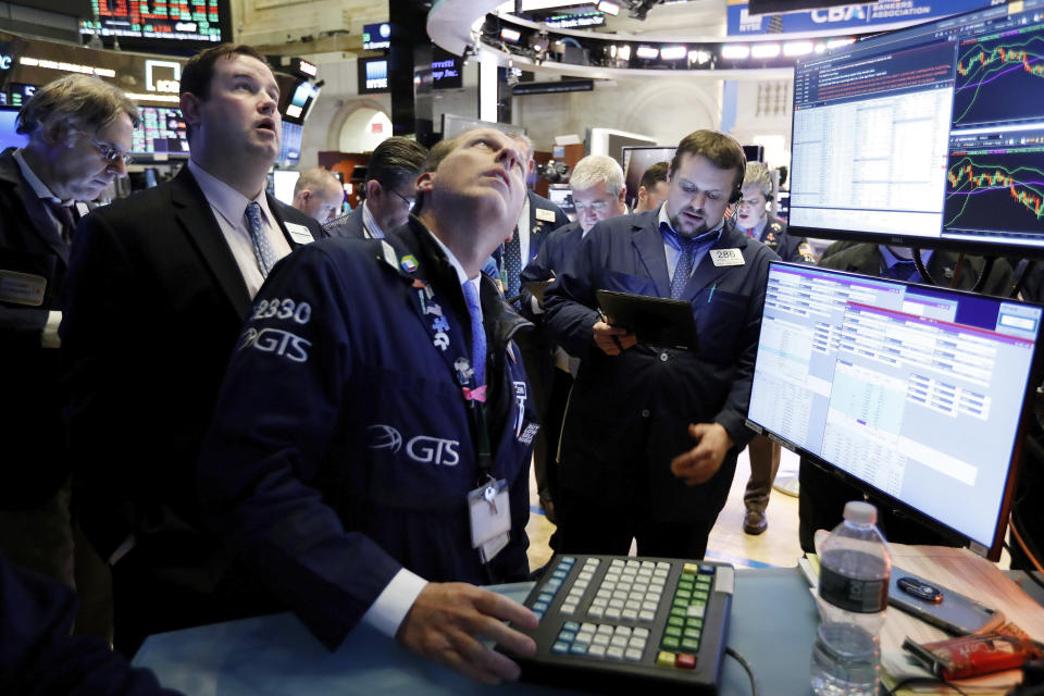 FILE - In this Jan. 15, 2020, file photo specialist Glenn Carell, center, works with traders at the post that handles NIO, a Chinese automobile manufacturer, on the floor of the New York Stock Exchange. The U.S. stock market opens at 9:30 a.m. EST on Tuesday, Jan. 21. (AP Photo/Richard Drew, File)