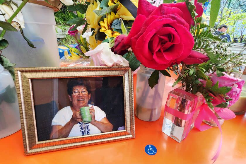 Customers leave flowers and other gifts on the outdoor patio at Tacos Delta in Silver Lake to honor the restaurant's founder Maria Esther Valdivia, who died May 25 after being hit by a car on May 22.
