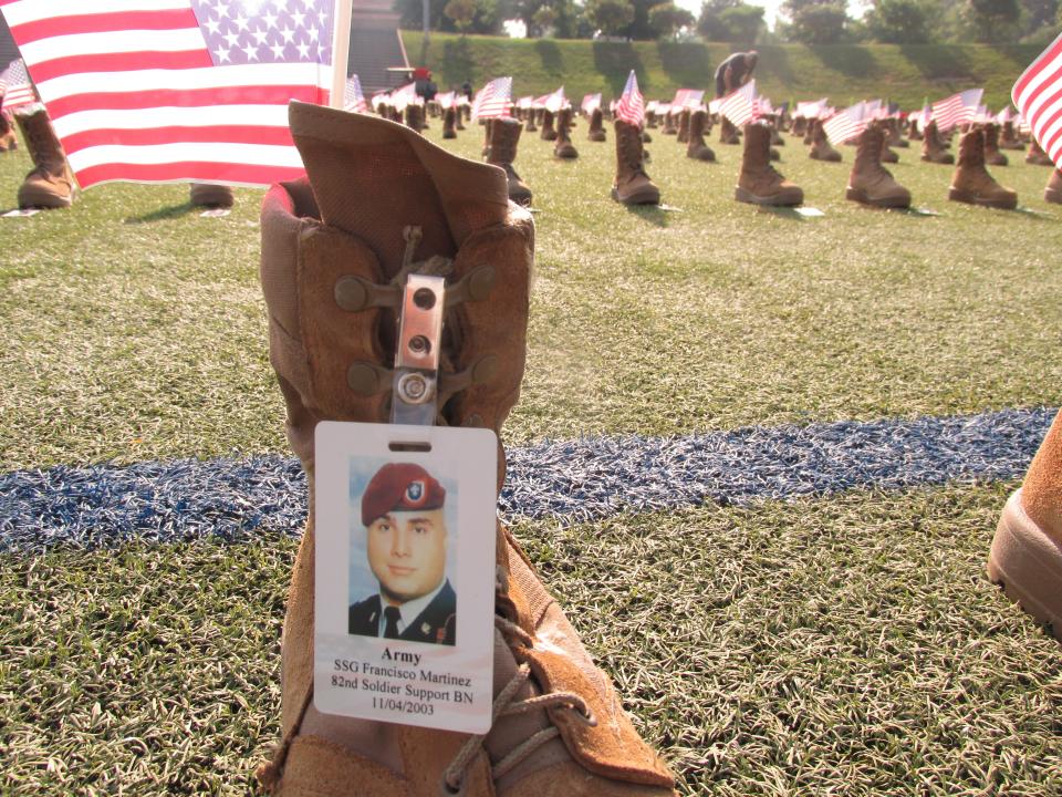 Volunteers place more than 7,500 boots out Friday, May 20, 2022, at Hedrick Stadium on Fort Bragg to represent service members who have died since 9/11.
