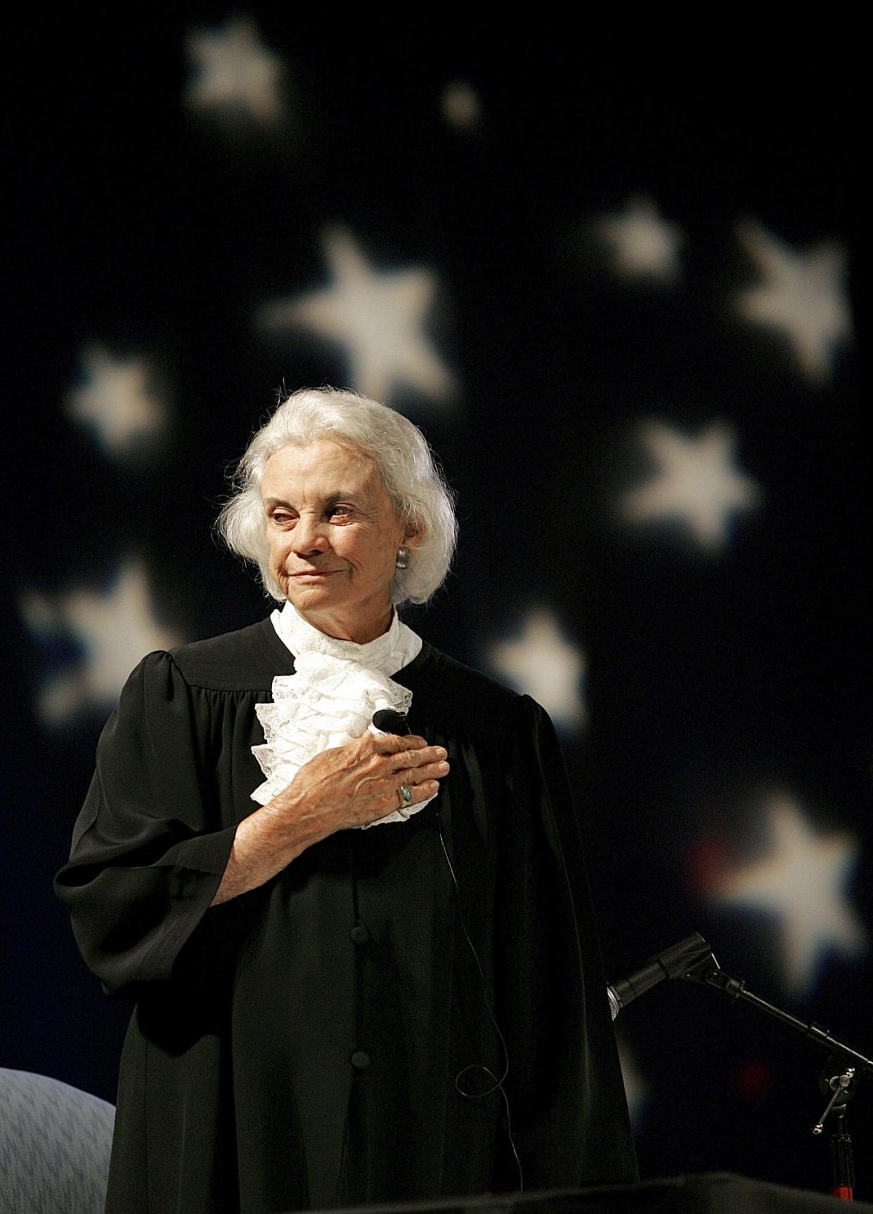 Supreme Court Justice Sandra Day O'Connor pledges allegiance to the flag in this Sept. 17, 2005, file photo at an open-air Immigration and Naturalization citizenship hearing in Gilbert, Ariz. In possibly her last day on the bench.