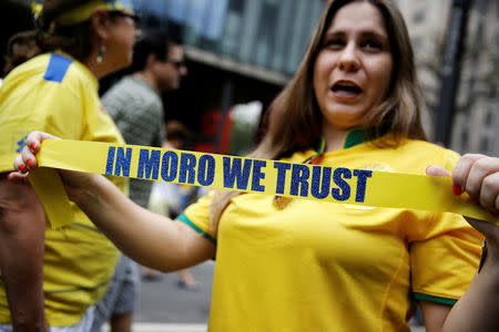 A woman holds a ribbon in reference to Brazil's federal judge Sergio Moro as she attends a protest against corruption at Paulista Avenue in Sao Paulo, Brazil, December 4, 2016. REUTERS/Nacho Doce