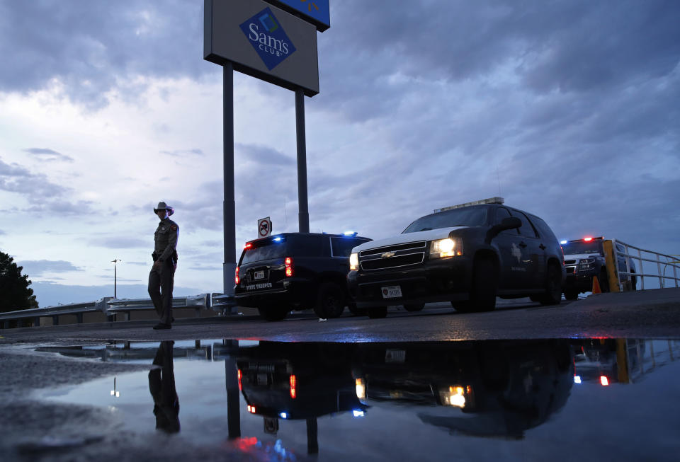 Law enforcement officials block a road at the scene of a mass shooting at a shopping complex on Aug. 4, 2019, in El Paso, Texas. (Photo: John Locher/AP)