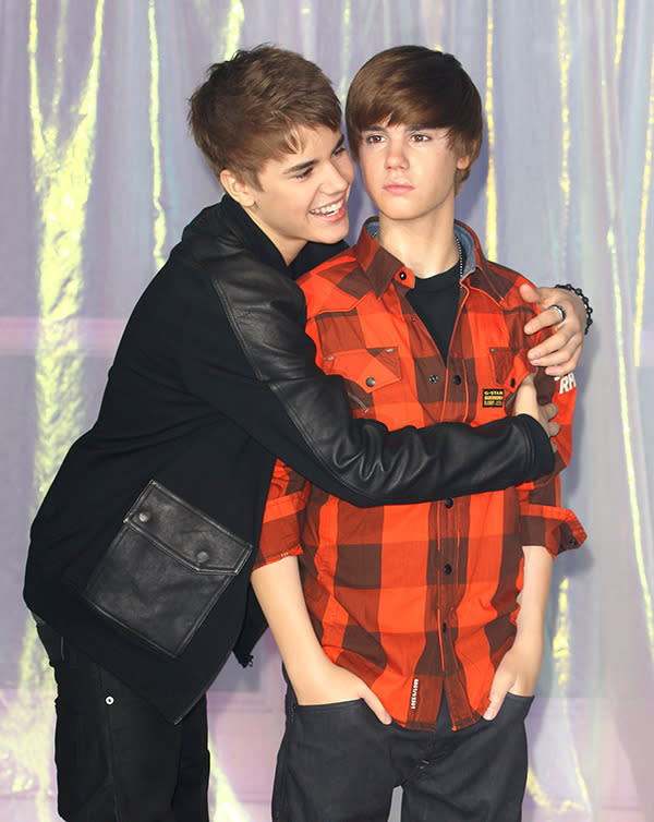 Look who's got Bieber fever now! The teen star hugs it out with his wax figure at its London unveiling March 15, 2011, at Madame Tussauds. "Knew [my mum] had more kids!" he joked on Twitter.