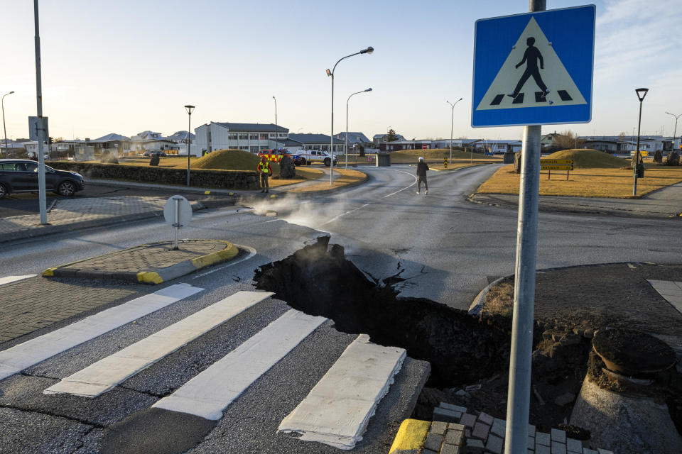 A big crack cut across the main road in Grindavik, in southwestern Iceland, following earthquakes. Grindavik, home to around 4,000 people, was evacuated in the early hours of Nov. 11 after magma shifting under the Earth's crust caused hundreds of earthquakes in what experts warned could be a precursor to a volcanic eruption.  / Credit: KJARTAN TORBJOERNSSON/AFP via Getty Images