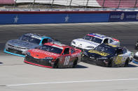 Daniel Hemric (18) drives along with John H. Nemechek (54), Sam Mayer (8) and Brandon Jones (19) during a NASCAR Xfinity Series auto race at Texas Motor Speedway Saturday, Oct. 16, 2021, in Fort Worth, Texas. (AP Photo/Larry Papke)