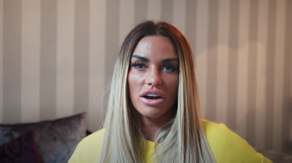 Katie Price in a yellow jumper talking to the camera