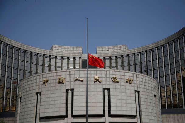 FILE PHOTO: The Chinese national flag flies at half-mast at the headquarters of the People's Bank of China, as China holds a national mourning for those who died of COVID-19, on the Qingming tomb-sweeping festival in Beijing, China April 4, 2020. (Carlos Garcia Rawlins/Reuters)